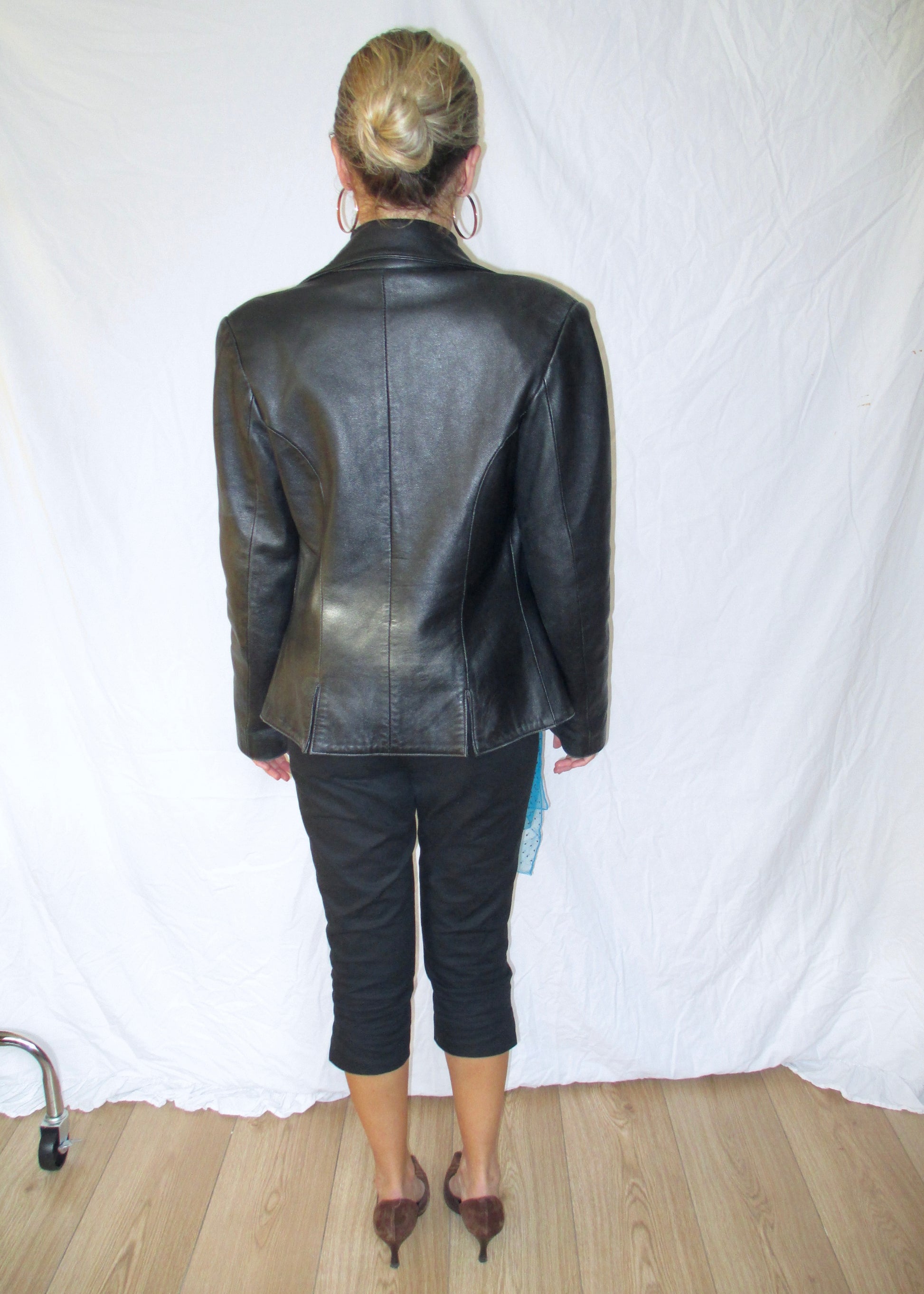 black leather blazer black capri trousers 2yk suede kitten heels with blue vintage details and ysl glasses back view