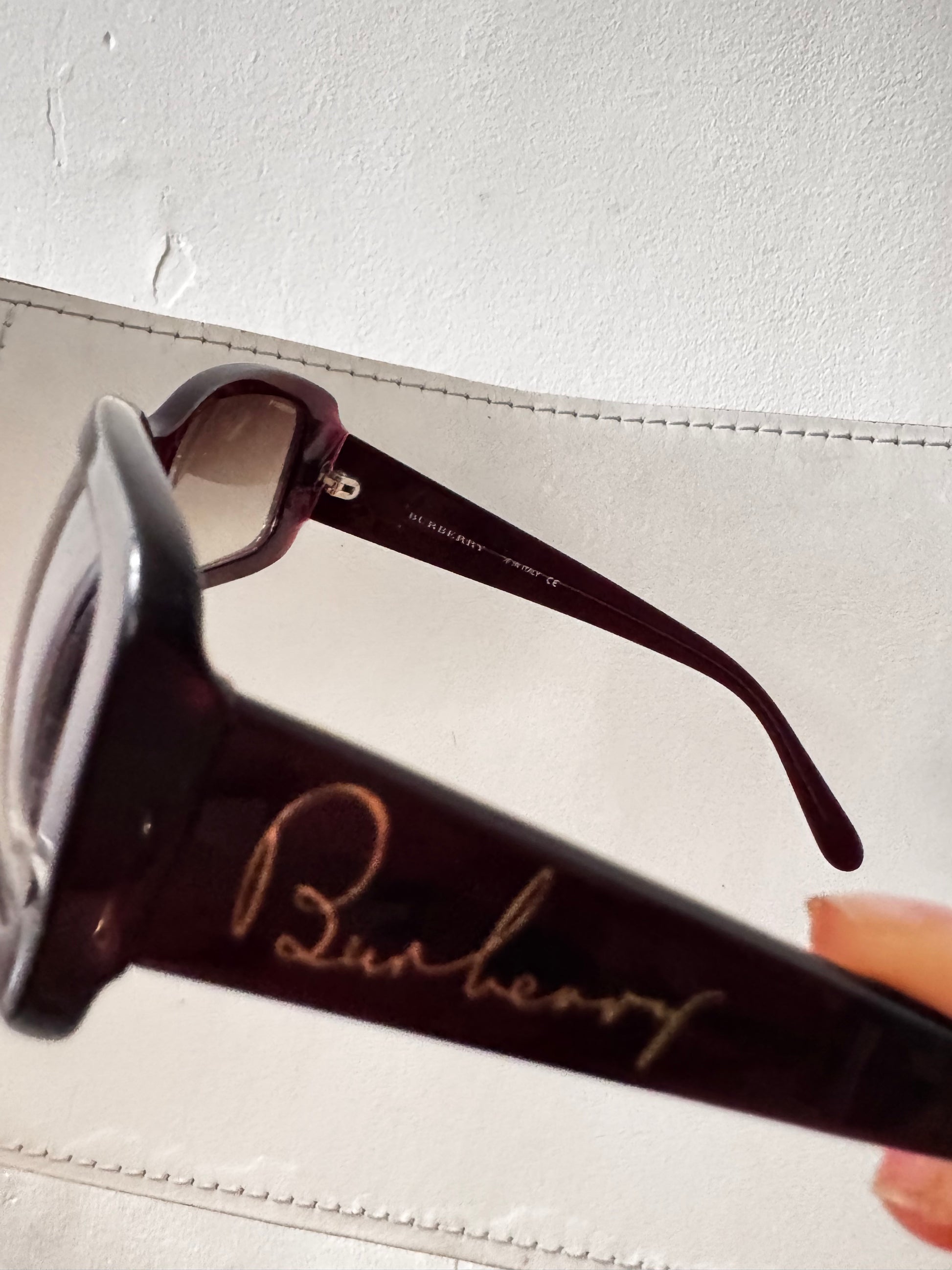 burberry glasses close up burgundy brown gold logo