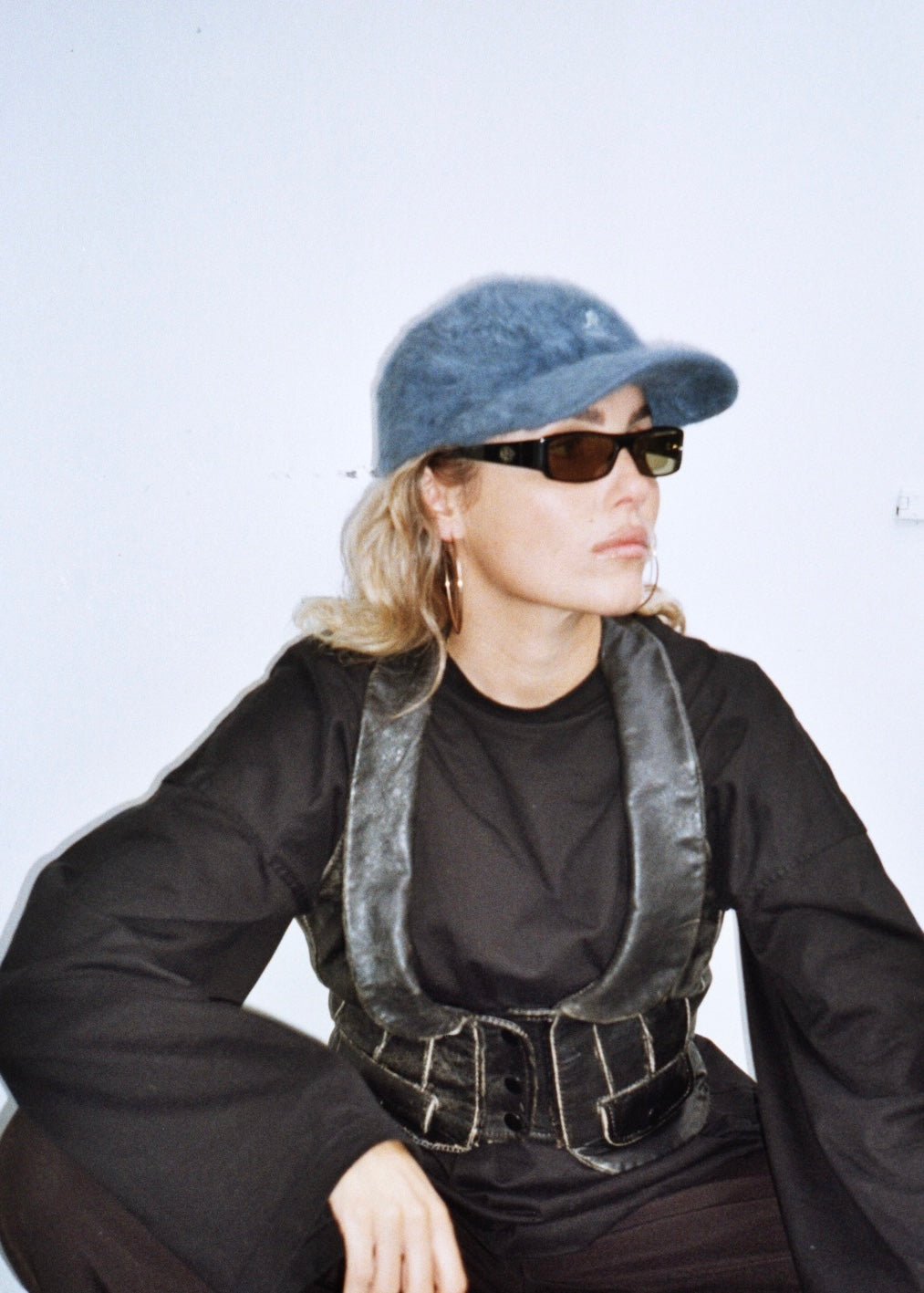 leather vintage waistcoat corset crop top with army shorts and vintage leather boots full outfit gucci sunglasses kangol angorra cap